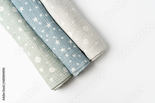 Photos Three rolled muslin blankets on white backgorund
