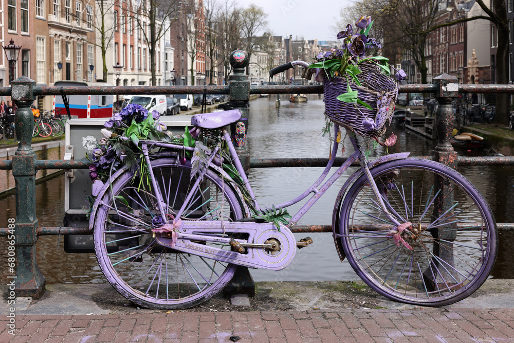  Old lavender colored bicycle on the bridge in De Wallen - called the red light district. It is famous for its entertainment character