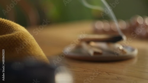Smoking aromatic incense in modern home, changing focus view photo