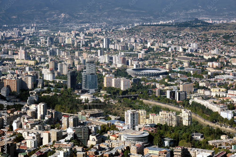 Aerial view of a large modern city with tall buildings.