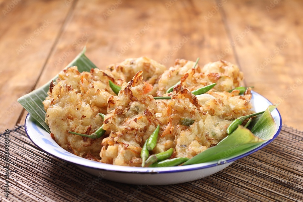 Bakwan sayur is Indonesian deep fried vegetable fritters. Found nation wide, mostly sold by street food vendors, the most popular version uses a mix of cabbage, carrot, and mung bean sprouts.