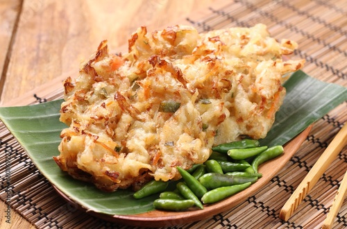 Bakwan sayur is Indonesian deep fried vegetable fritters. Found nation wide, mostly sold by street food vendors, the most popular version uses a mix of cabbage, carrot, and mung bean sprouts. photo