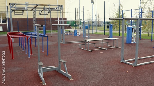 outdoor metal exercise equipment on a sports ground without people, a sports lifestyle in an urban space, equipment for street strength training, sports in an urban environment