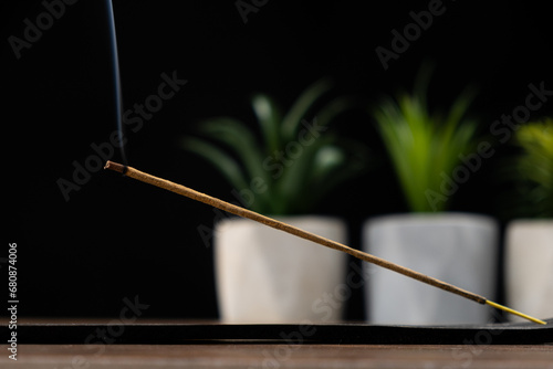 Incense stick on black background, incense smoke, for meditation and aromatherapy.