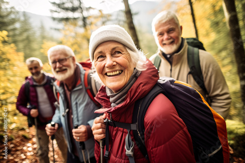 A diverse group of elderly friends, all in their 70s, hiking together on a mountain trail during early autumn