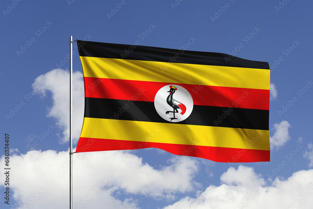 Uganda flag fluttering in the wind on sky. Uganda flag fluttering in the wind on sky.