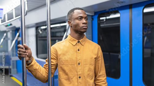 Portrait of an African American man in a bright yellow shirt who rides on public transport
