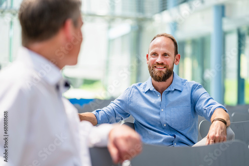 Confident businessman meeting colleague in company auditory photo