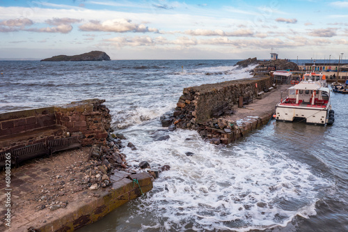 UK, Scotland, North Berwick, Breach in harbor sea defence wall after Storm Babet photo