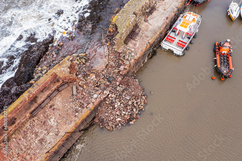 UK, Scotland, North Berwick, Aerial view of breach in harbor sea defence wall after Storm Babet