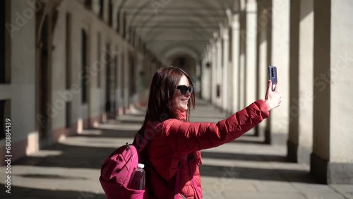 Turin. The girl is posing on the phone. A tourist walks around the city. photo