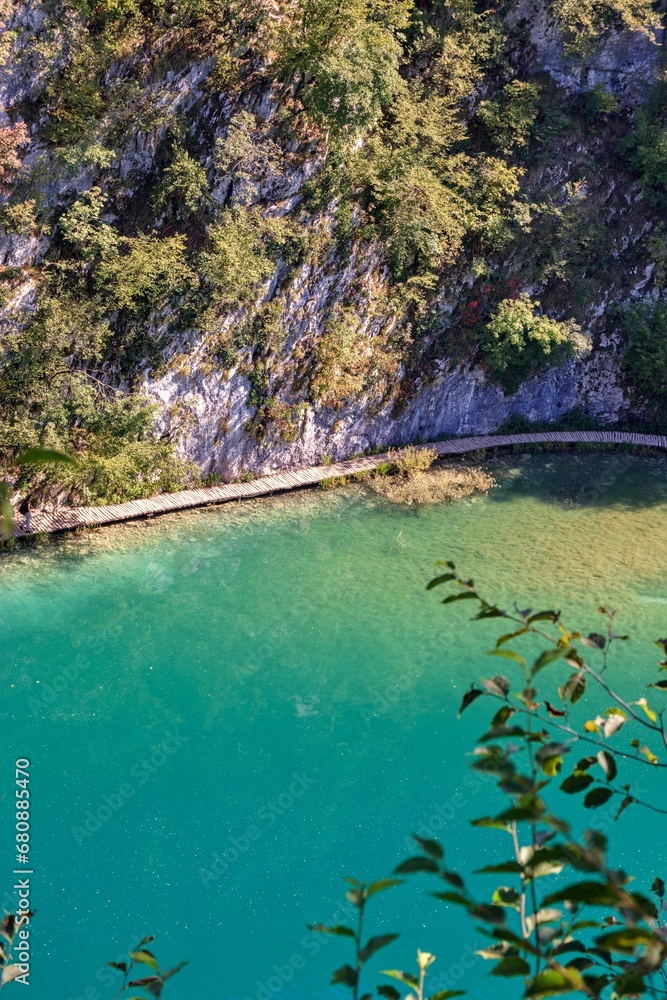 A scenic view to the Matica lake with clean green surface and wooden footpath at Plitvice lakes, Croatia