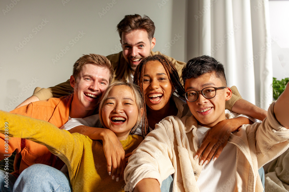 multiracial group of young friends smiling and taking selfies for the camera, asian, african american and european multiracial group of young friends smiling and taking selfies for the camera, asian, african american and european