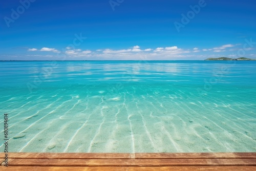 long wooden pier stretching out into crystal clear ocean