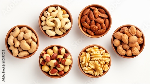 Cashew, hazelnut, almond, Brazil nut, walnut, peanut, pistachios, macadamia, and pecan nuts isolated on white backdrop with clipping path.