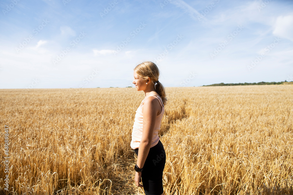 Girl standing in wheat field Girl standing in wheat field