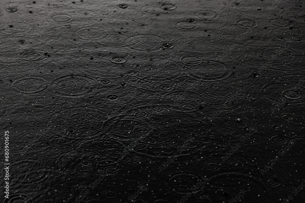 Ripples from raindrops in puddle Ripples from raindrops in puddle