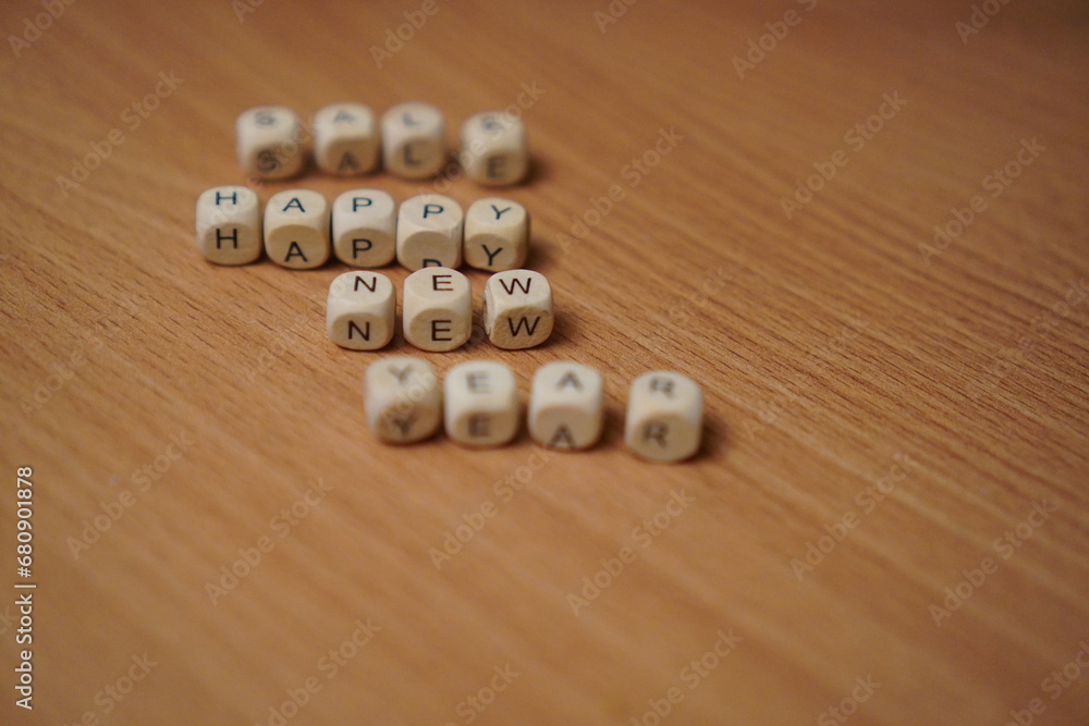 inscription made of wooden cubes happy new year sale on the table close-up with free space for text insertion inscription made of wooden cubes happy new year sale on the table close-up with free space for text insertion