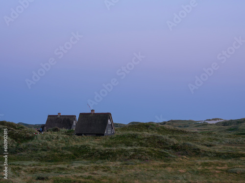 Cabins in grass on sand dunes