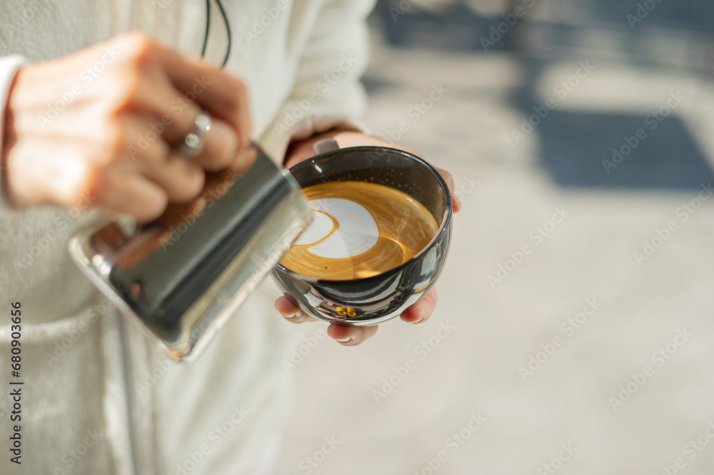closeup hand doing hot latte art coffee closeup hand doing hot latte art coffee