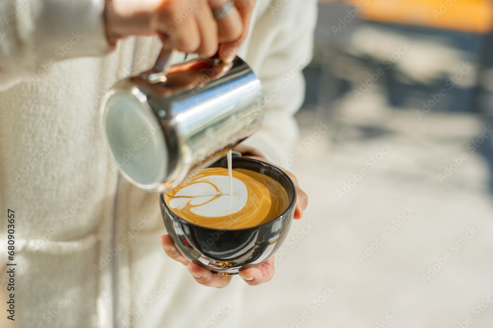 closeup hand doing hot latte art coffee closeup hand doing hot latte art coffee