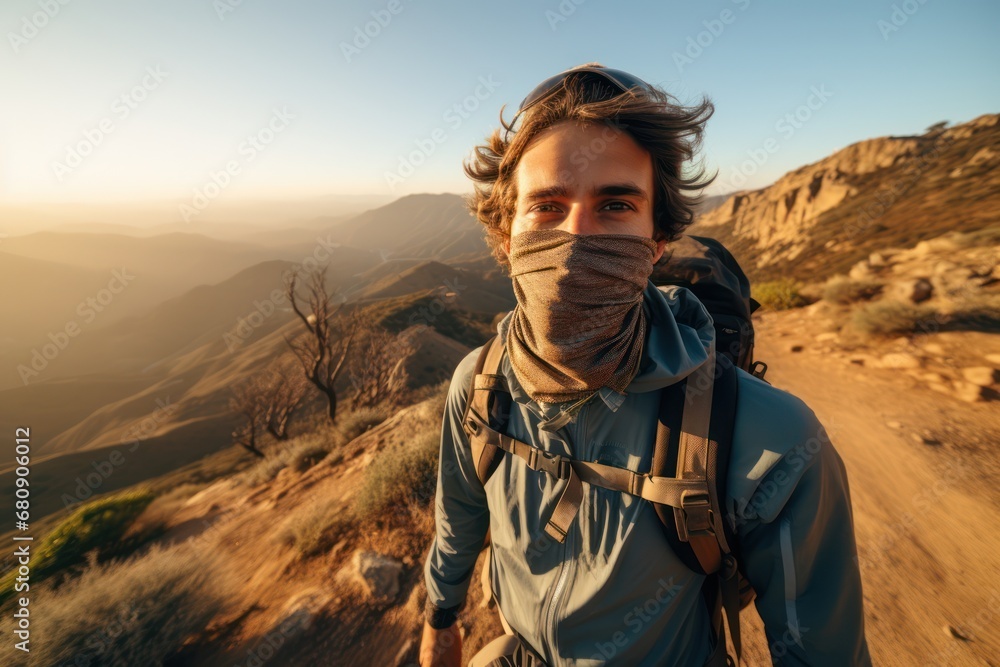 Solo brave traveler walk to mountain summit wearing professional travel equipment. Yong hiker traveling across mountain track among high altitude sunny rok. Wide image Solo brave traveler walk to mountain summit wearing professional travel equipment. Yong hiker traveling across mountain track among high altitude sunny rok. Wide image