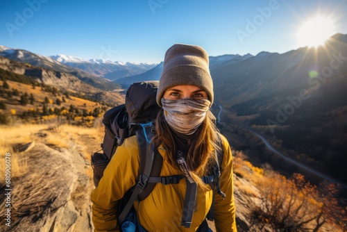 Solo brave traveler walk to mountain summit wearing professional travel equipment. Yong hiker traveling across mountain track among high altitude sunny rok. Wide image