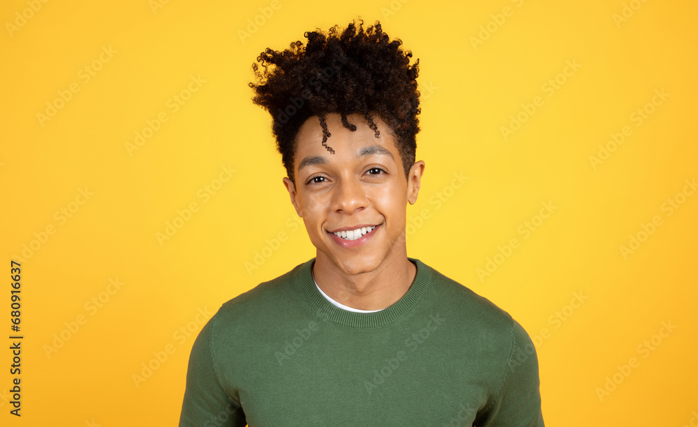 Portrait of smiling young black guy hipster posing on yellow Portrait of smiling young black guy hipster posing on yellow