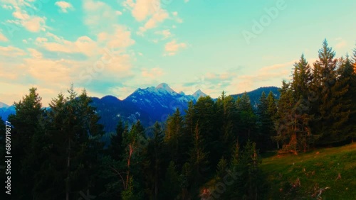 Beautiful Sunrise Over Austrian Mountains: Scenic Lake, Dense Forest, and Hiking Trails Through Trees and Wilderness Captured in Stunning Morning Light