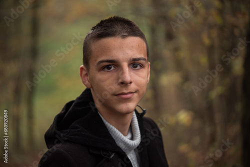 a 16-year-old teenager poses outside
