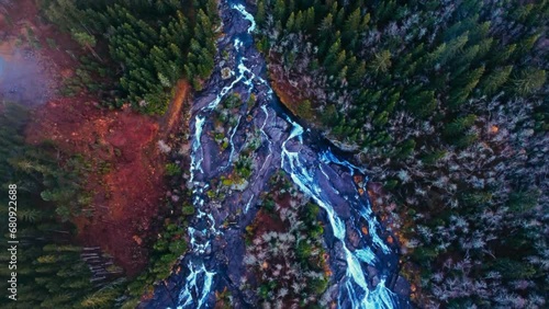 Drone Footage of Dramatic Mountains, Fjord Waters, and Waterfall Cascading Through Trees and Clouds in a Stunning Landscape