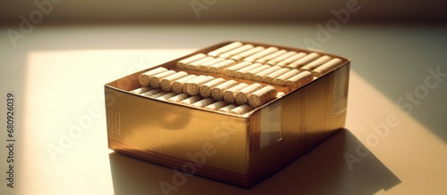 Box of cigarettes on a wooden table against the background of the sunset