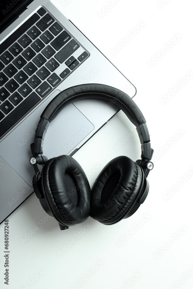 Big headphones, on a table with a laptop. Big headphones, on a table with a laptop.