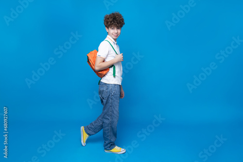 Curly teenager with a briefcase, on a blue background.