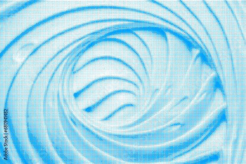 Marshmallow, twisted into spiral, close-up, from blue circle dots of different sizes on white background