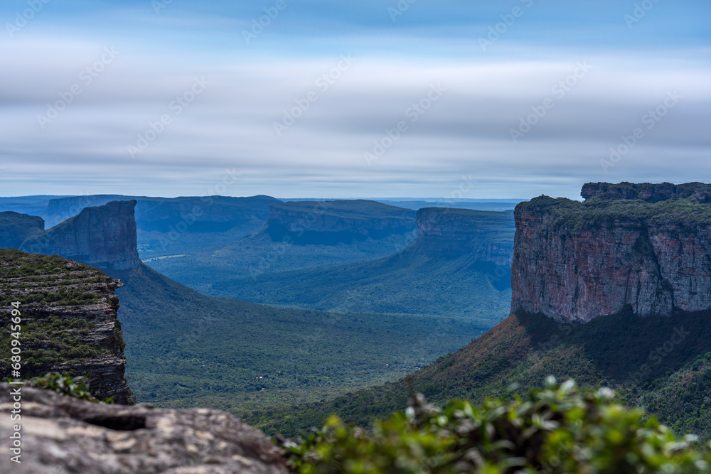 Majestic long exposure of lush valley surrounded by towering sandstone cliffs Majestic long exposure of lush valley surrounded by towering sandstone cliffs
