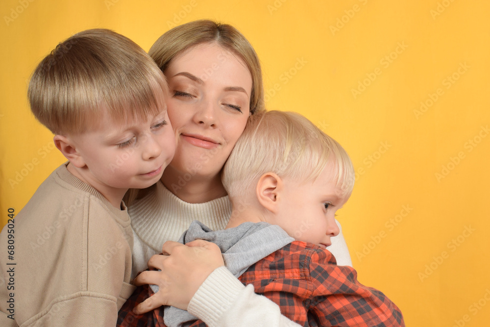 happy mother hugs her little sons happy mother hugs her little sons