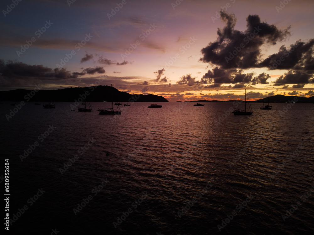 Dramatic landscape with sunset on the sea shore. Beautiful cloudy sky.