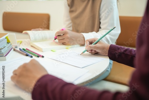 Learning with friends Young students campus.High School Tutor for examining helps school homework together with friend catching up and learning