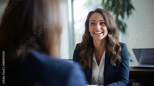 Smiling Female Manager Interviewing an Applicant In Office 