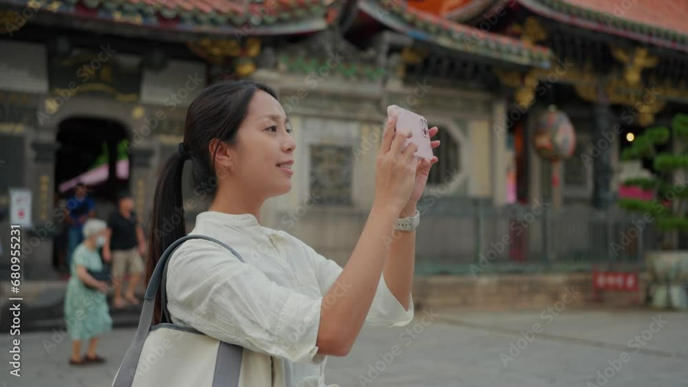 Woman use mobile phone to take photo in Chinese temple Woman use mobile phone to take photo in Chinese temple