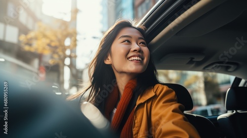 Young beautiful asian women getting new car. she very happy and excited looking outside  photo