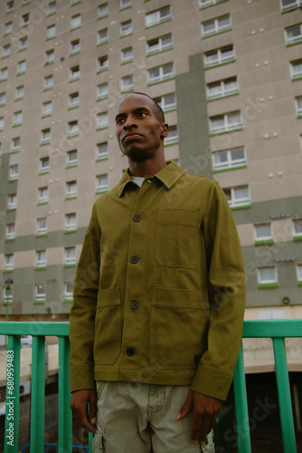 Portrait of fashionable autistic black man posing in front of building