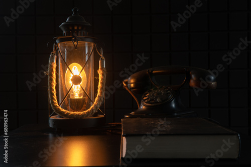 Vintage lamp and telephone. A study with rarities. A cozy atmospheric photo that transports us to another century photo