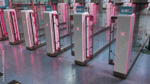 Airport security with closed turnstiles doors featuring X signs, restricting access to ensure safety and control limiting entrance to the restricted area photo