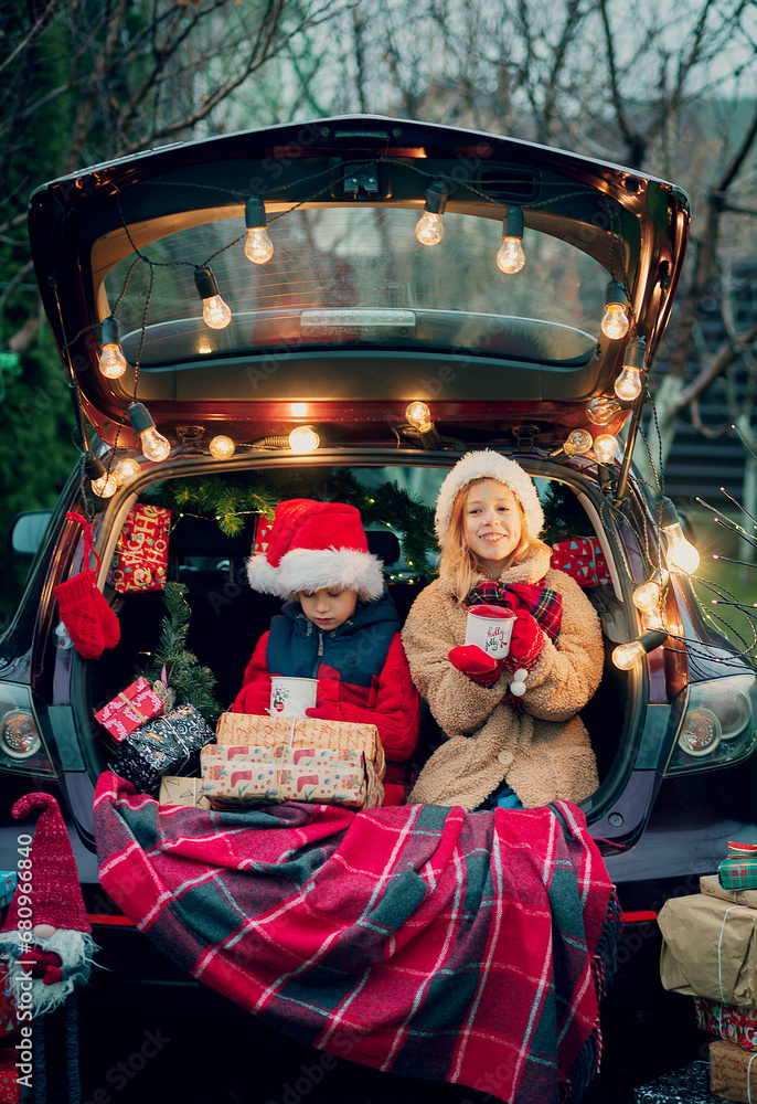 Obraz premium Merry Christmas. children with Christmas gifts outdoors