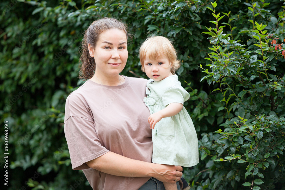 Fototapeta premium Mom with a one-year-old girl in her arms