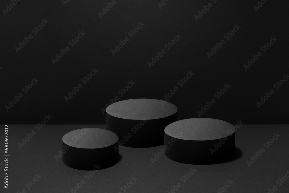 Abstract black scene with three cylinder podiums template with light beams for presentation cosmetic products, goods, advertising, design, poster. Black stage template rich contemporary concert style. Abstract black scene with three cylinder podiums template with light beams for presentation cosmetic products, goods, advertising, design, poster. Black stage template rich contemporary concert style.