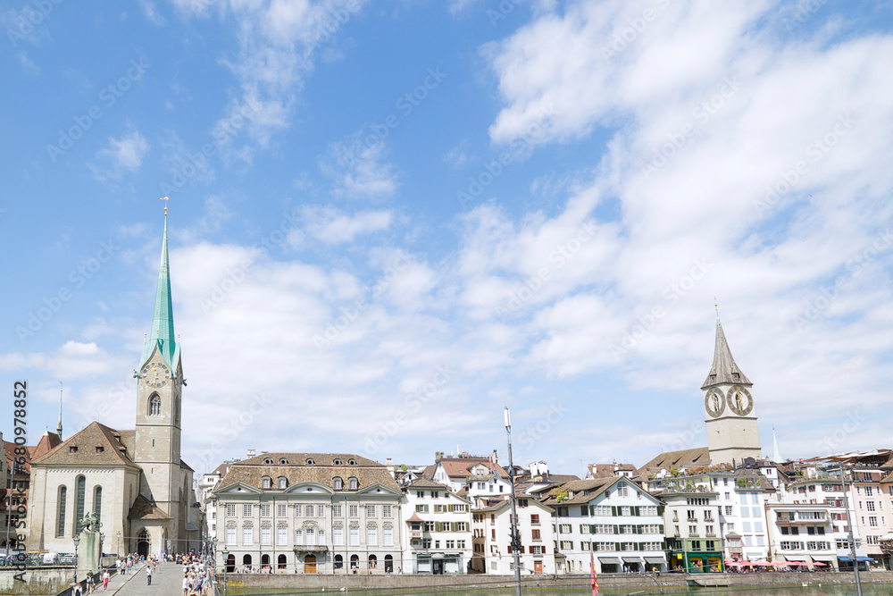 View of the historic city center with famous Saint Peter and Fraumünster Church, on the Limmat river. Zurich, Switzerland. .