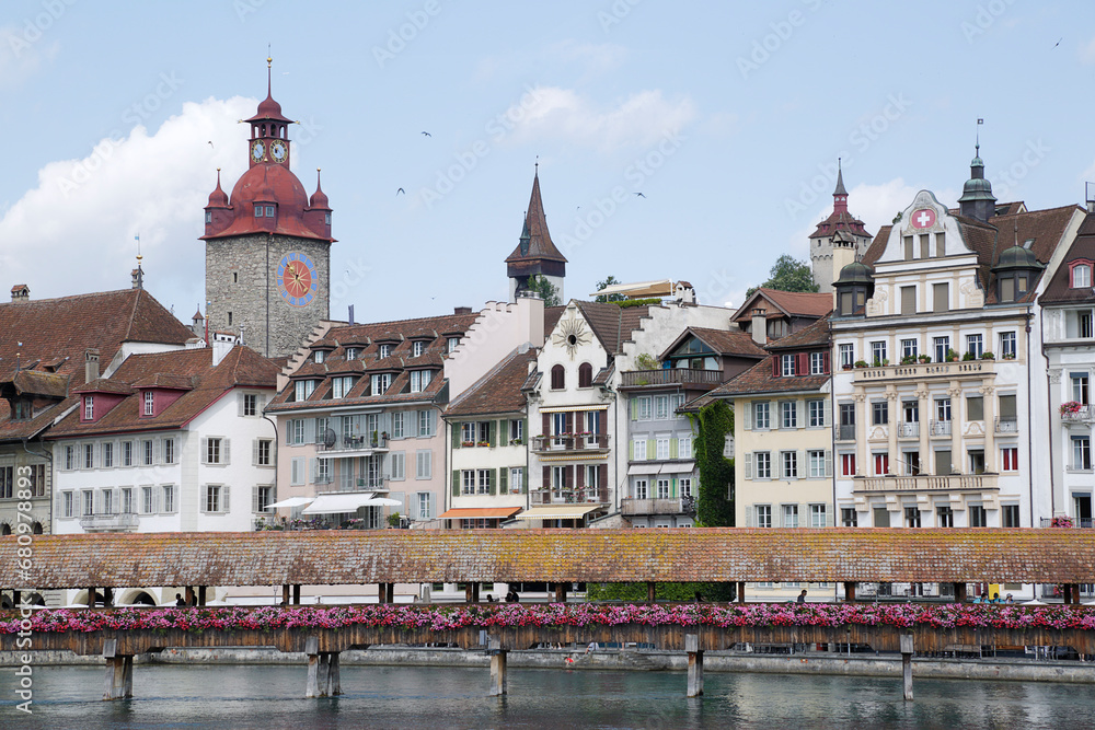 View on the riverside with city hall and old wooden bridge in Lucerne old town in Switzerland